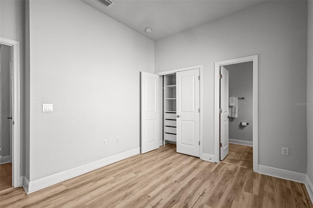 15329 Renaissance Ave, Odessa, FL 33556 - unfurnished bedroom with light wood-style floors, a closet, baseboards, and ensuite bathroom