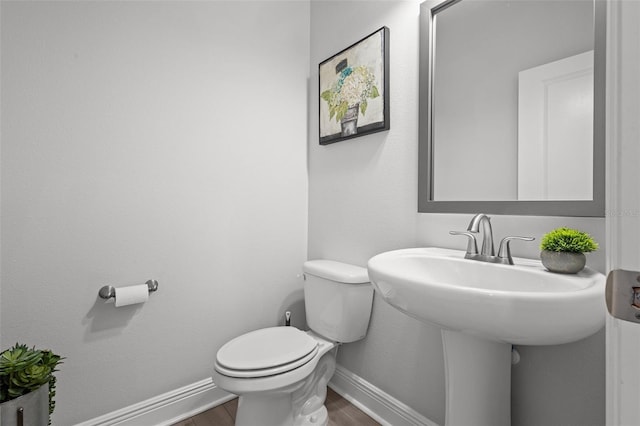 15329 Renaissance Ave, Odessa, FL 33556 - bathroom with baseboards, wood finished floors, and toilet