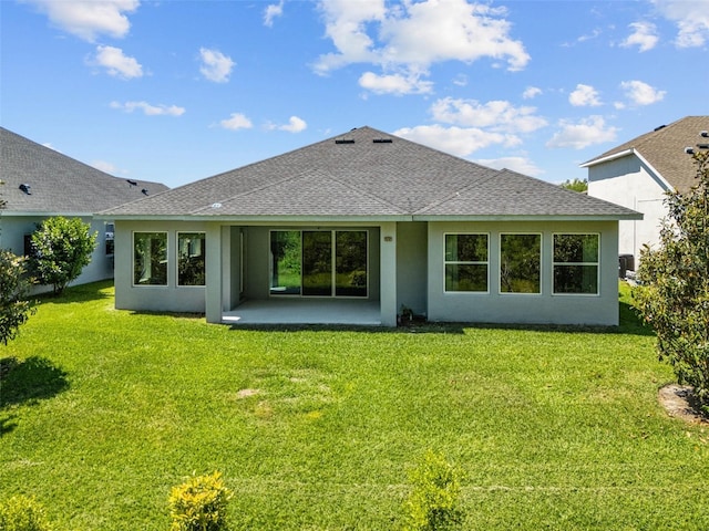 15329 Renaissance Ave, Odessa, FL 33556 - back of property featuring a patio area, a lawn, a shingled roof, and stucco siding