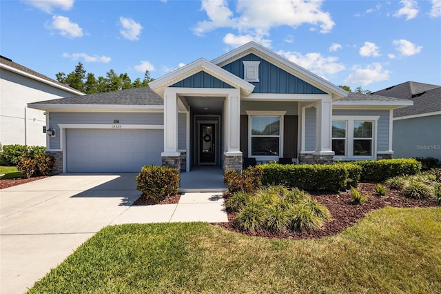 15329 Renaissance Ave, Odessa, FL 33556 - craftsman-style house featuring driveway, stone siding, board and batten siding, an attached garage, and a front yard