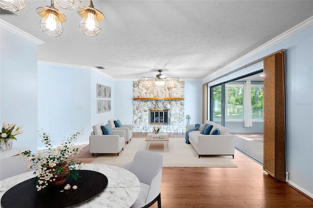 living area with a ceiling fan, wood finished floors, and ornamental molding
