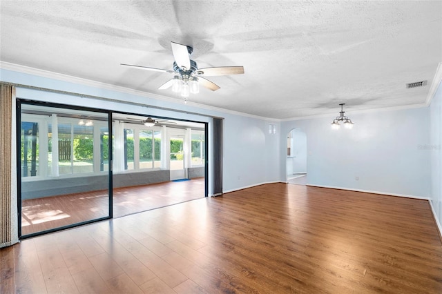 interior space featuring arched walkways, wood finished floors, a textured ceiling, and ceiling fan with notable chandelier