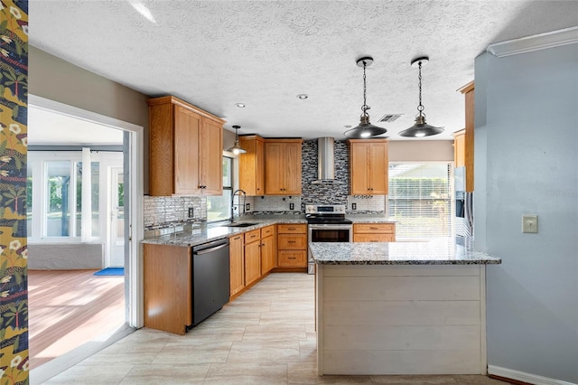 kitchen featuring wall chimney range hood, visible vents, a wealth of natural light, decorative backsplash, and appliances with stainless steel finishes