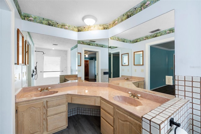 full bath featuring a sink, visible vents, and double vanity