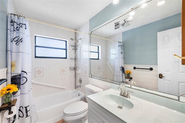full bath featuring wainscoting, vanity, tile walls, shower / bath combination with curtain, and toilet