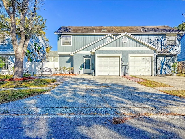 16819 Stanza Ct, Tampa, FL 33624 - view of front of house with fence, driveway, roof with shingles, and a garage