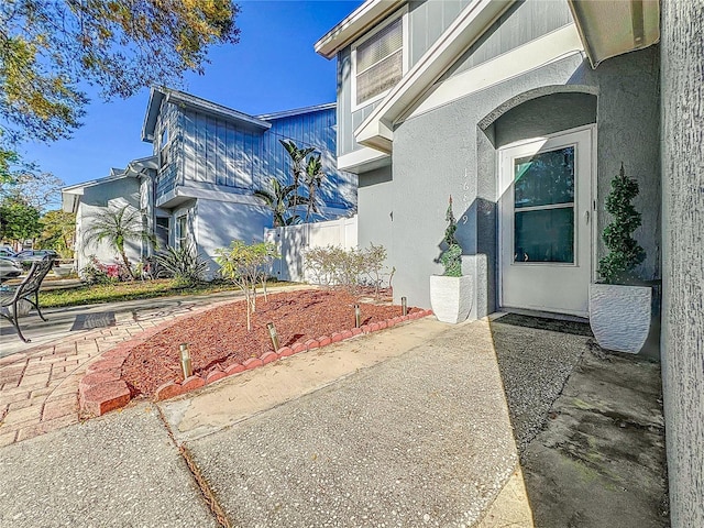 16819 Stanza Ct, Tampa, FL 33624 - view of side of property with stucco siding and a patio area