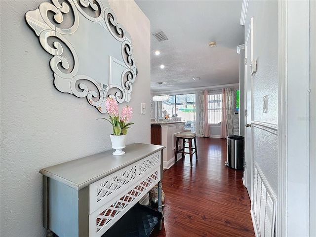 16819 Stanza Ct, Tampa, FL 33624 - hall with dark wood-style floors, visible vents, a textured wall, and baseboards