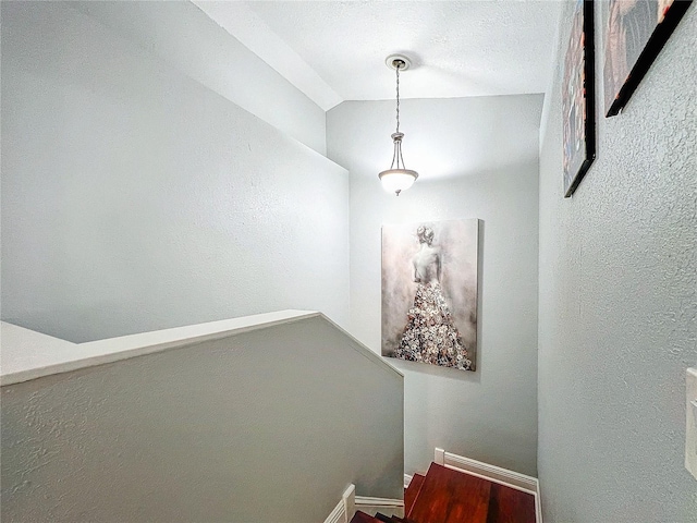 16819 Stanza Ct, Tampa, FL 33624 - staircase featuring lofted ceiling and a textured wall