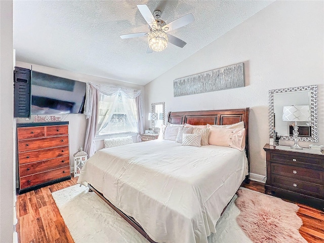 16819 Stanza Ct, Tampa, FL 33624 - bedroom featuring vaulted ceiling, wood finished floors, a textured ceiling, and ceiling fan