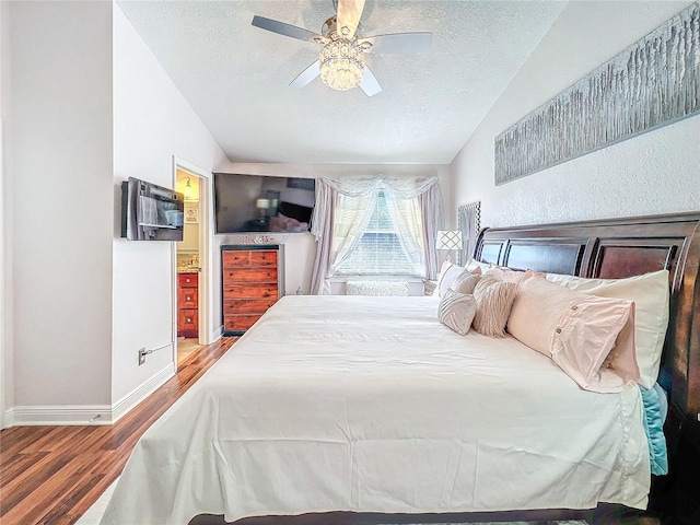16819 Stanza Ct, Tampa, FL 33624 - bedroom with vaulted ceiling, wood finished floors, and a textured ceiling