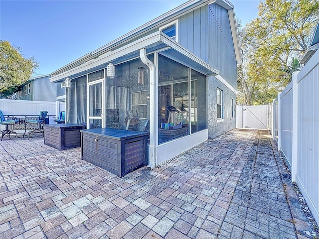 16819 Stanza Ct, Tampa, FL 33624 - view of patio / terrace with a fenced backyard, a sunroom, and a gate