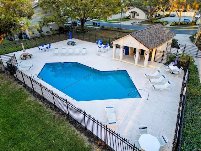 16819 Stanza Ct, Tampa, FL 33624 - community pool featuring a yard, a patio, and fence