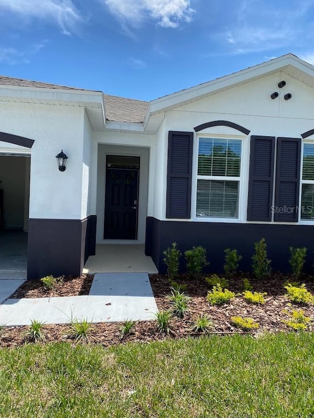 7937 Wheat Stone Dr, Zephyrhills, FL 33540 - property entrance with stucco siding