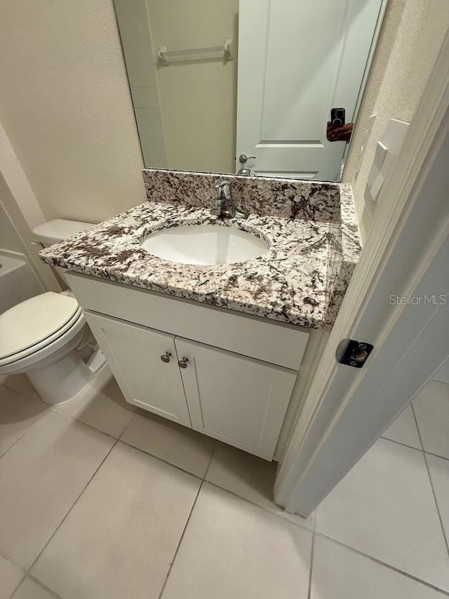 7937 Wheat Stone Dr, Zephyrhills, FL 33540 - bathroom featuring tile patterned floors, toilet, and vanity