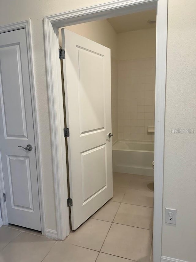7937 Wheat Stone Dr, Zephyrhills, FL 33540 - hallway with light tile patterned floors and baseboards