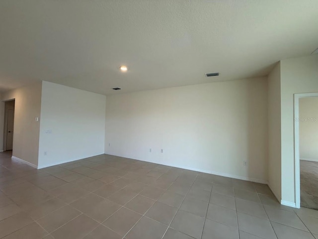 7937 Wheat Stone Dr, Zephyrhills, FL 33540 - spare room featuring light tile patterned floors, recessed lighting, baseboards, and a textured ceiling