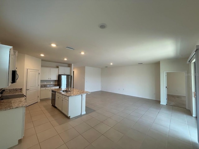 7937 Wheat Stone Dr, Zephyrhills, FL 33540 - kitchen with open floor plan, dishwasher, black microwave, a sink, and a center island