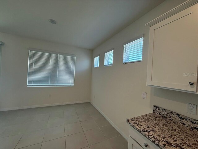 7937 Wheat Stone Dr, Zephyrhills, FL 33540 - unfurnished room with baseboards and light tile patterned floors