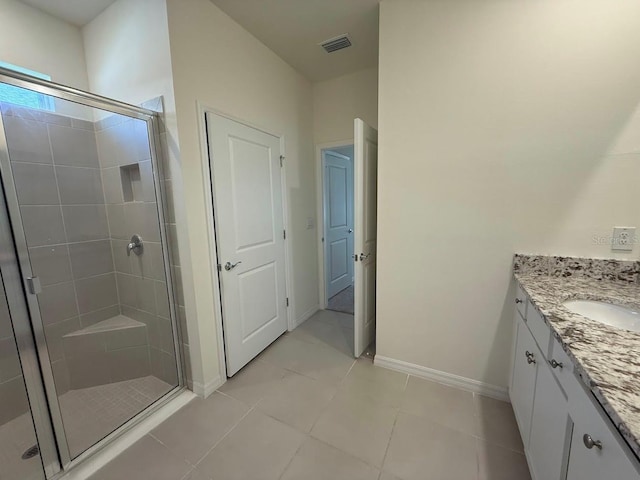 7937 Wheat Stone Dr, Zephyrhills, FL 33540 - bathroom with a stall shower, vanity, tile patterned flooring, and baseboards