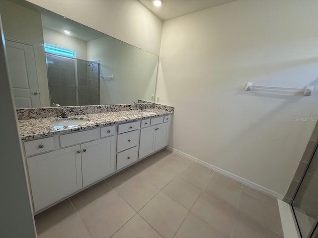 7937 Wheat Stone Dr, Zephyrhills, FL 33540 - full bath featuring a stall shower, double vanity, tile patterned flooring, and baseboards