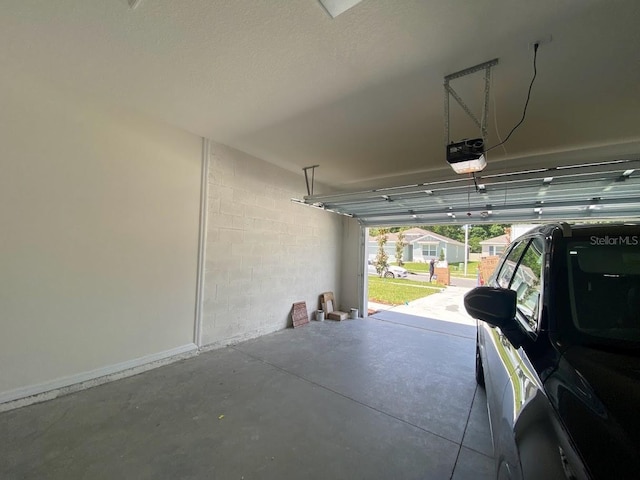 7937 Wheat Stone Dr, Zephyrhills, FL 33540 - garage featuring a garage door opener and baseboards