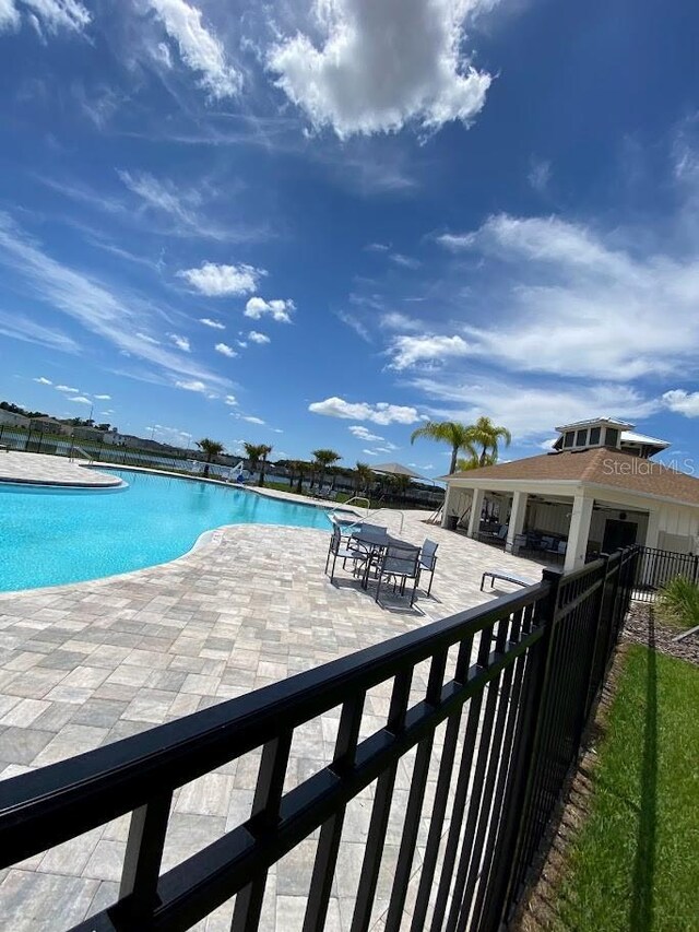 7937 Wheat Stone Dr, Zephyrhills, FL 33540 - community pool with fence and a patio