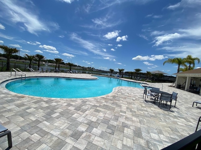 7937 Wheat Stone Dr, Zephyrhills, FL 33540 - community pool featuring fence and a patio