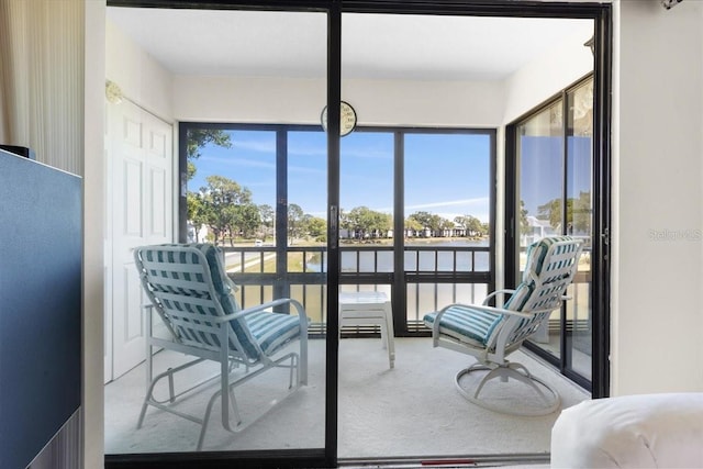 sunroom / solarium featuring a water view