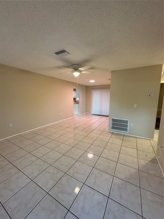 7601 Como Dr, New Port Richey, FL 34655 - unfurnished room featuring light tile patterned floors, visible vents, and ceiling fan