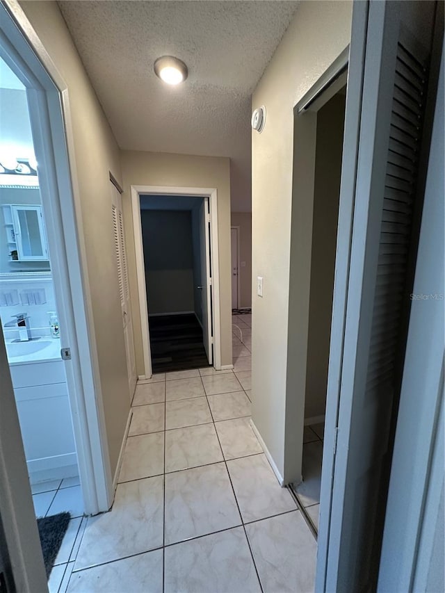 7601 Como Dr, New Port Richey, FL 34655 - hallway featuring a textured ceiling