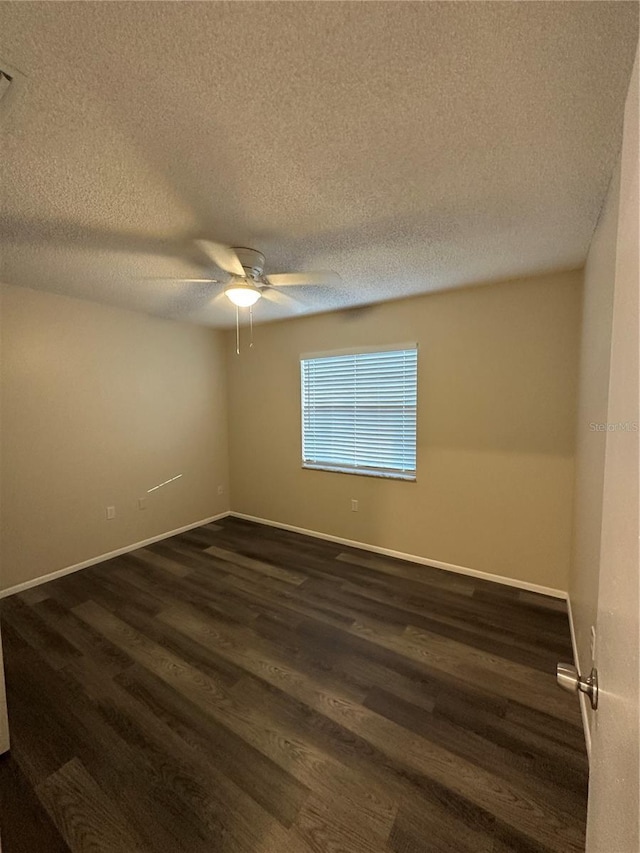 7601 Como Dr, New Port Richey, FL 34655 - unfurnished room with dark wood finished floors, a textured ceiling, a ceiling fan, and baseboards