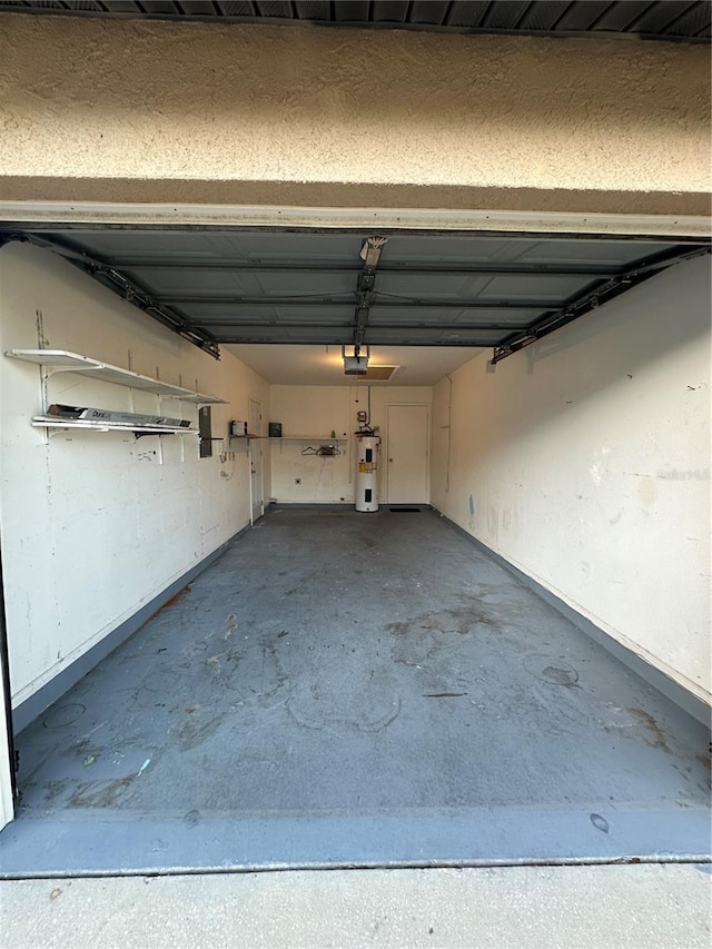 7601 Como Dr, New Port Richey, FL 34655 - garage featuring electric water heater and baseboards