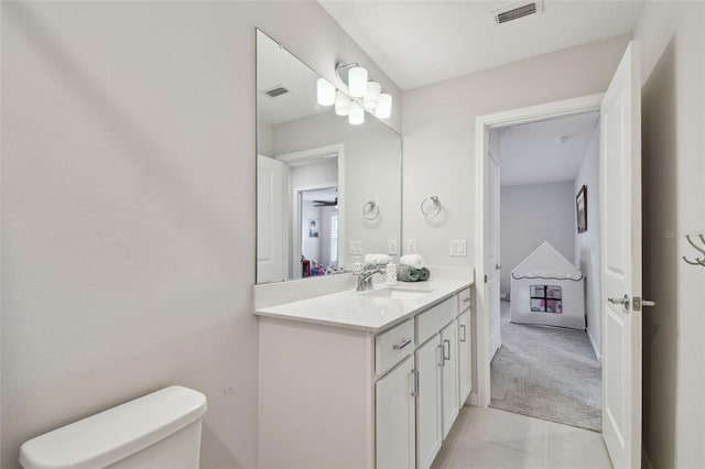 bathroom featuring vanity, tile patterned flooring, toilet, and visible vents
