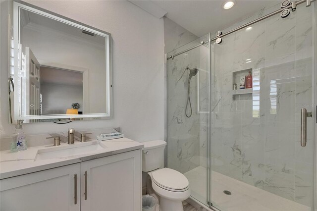 bathroom featuring recessed lighting, toilet, vanity, and a marble finish shower