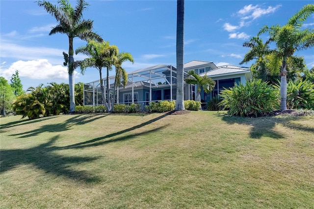 view of yard with glass enclosure