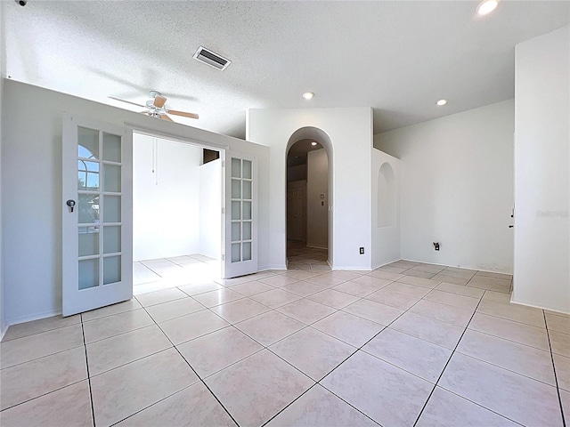 11535 Wellman Dr, Riverview, FL 33578 - empty room with arched walkways, a ceiling fan, visible vents, and light tile patterned floors
