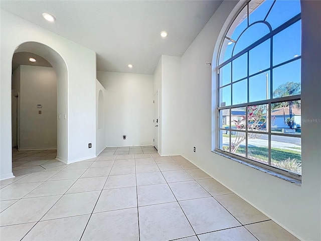 11535 Wellman Dr, Riverview, FL 33578 - unfurnished room with baseboards, arched walkways, recessed lighting, and light tile patterned floors