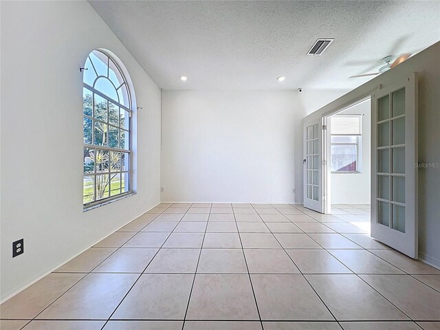 11535 Wellman Dr, Riverview, FL 33578 - spare room featuring french doors, a textured ceiling, visible vents, recessed lighting, and light tile patterned floors