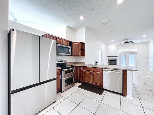 11535 Wellman Dr, Riverview, FL 33578 - kitchen featuring open shelves, a sink, light tile patterned flooring, stainless steel appliances, and a peninsula