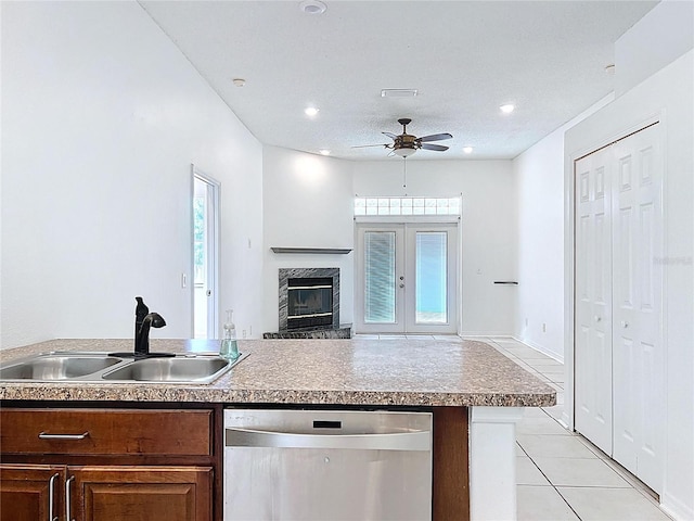 11535 Wellman Dr, Riverview, FL 33578 - kitchen featuring a high end fireplace, stainless steel dishwasher, a sink, open floor plan, and ceiling fan