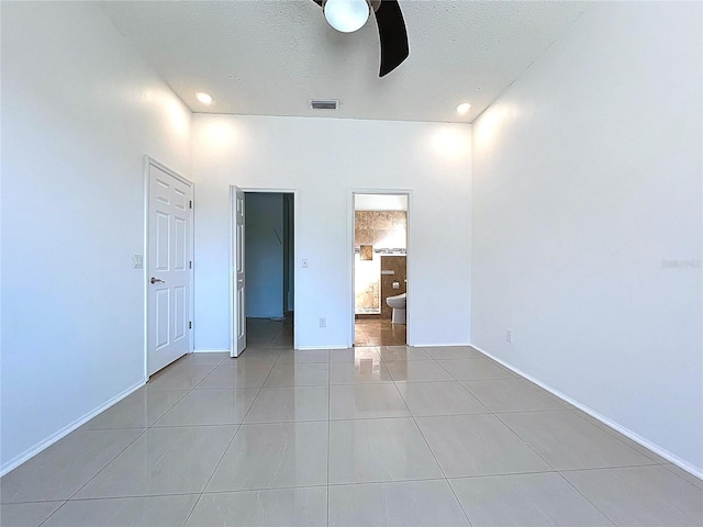 11535 Wellman Dr, Riverview, FL 33578 - unfurnished bedroom featuring a walk in closet, a textured ceiling, visible vents, and light tile patterned flooring