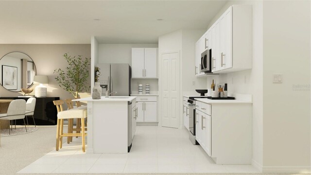 5026 Barnet Dr, Davenport, FL 33837 - kitchen with an island with sink, white cabinets, appliances with stainless steel finishes, and a breakfast bar