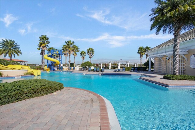 5026 Barnet Dr, Davenport, FL 33837 - community pool with a water slide, a pergola, and a patio area
