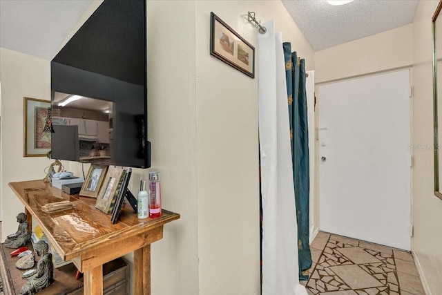hallway featuring a textured ceiling