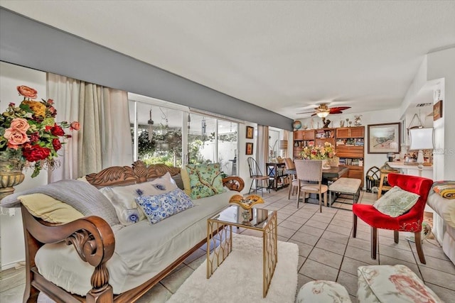 living room with ceiling fan and light tile patterned floors