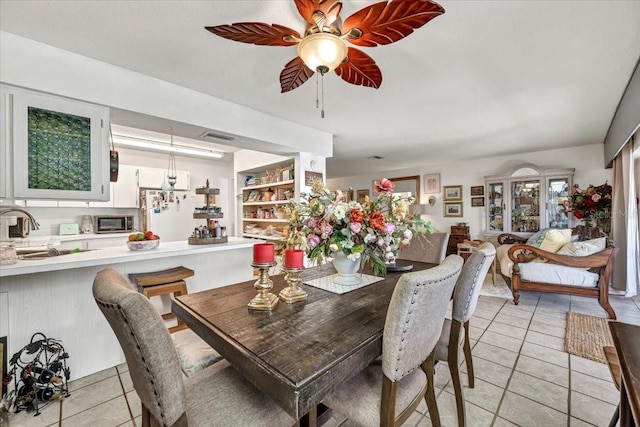 dining room featuring a ceiling fan, visible vents, and light tile patterned floors