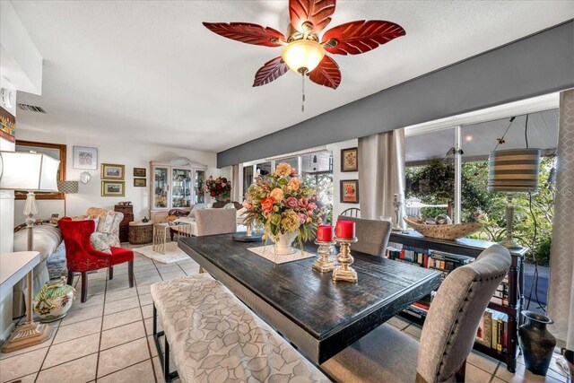 dining area with ceiling fan, visible vents, and light tile patterned floors