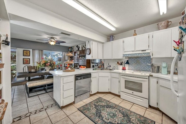 kitchen with a peninsula, stainless steel dishwasher, electric range, visible vents, and under cabinet range hood