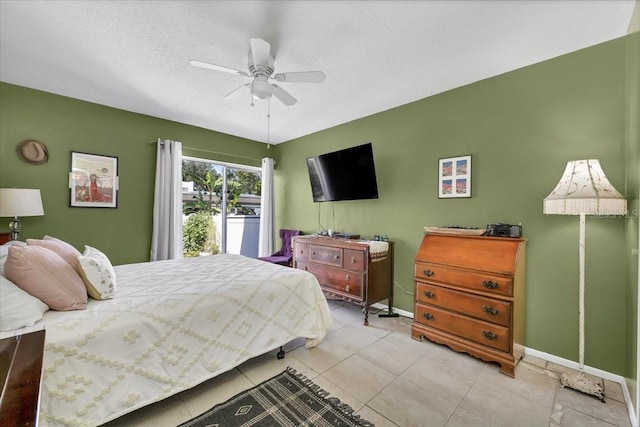 bedroom featuring baseboards, tile patterned flooring, a textured ceiling, and ceiling fan